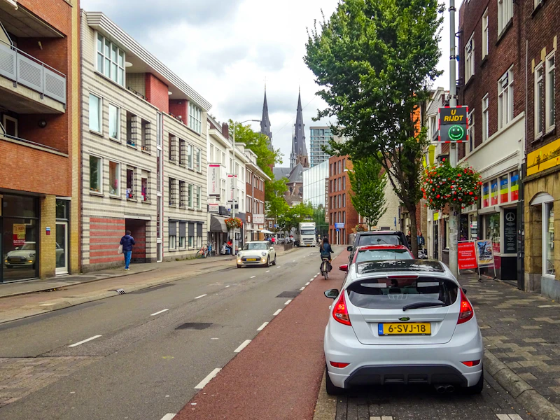 Street view with cars and buildings in a city.