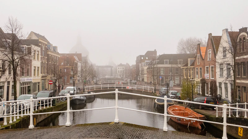 a boat is docked on the side of a canal
